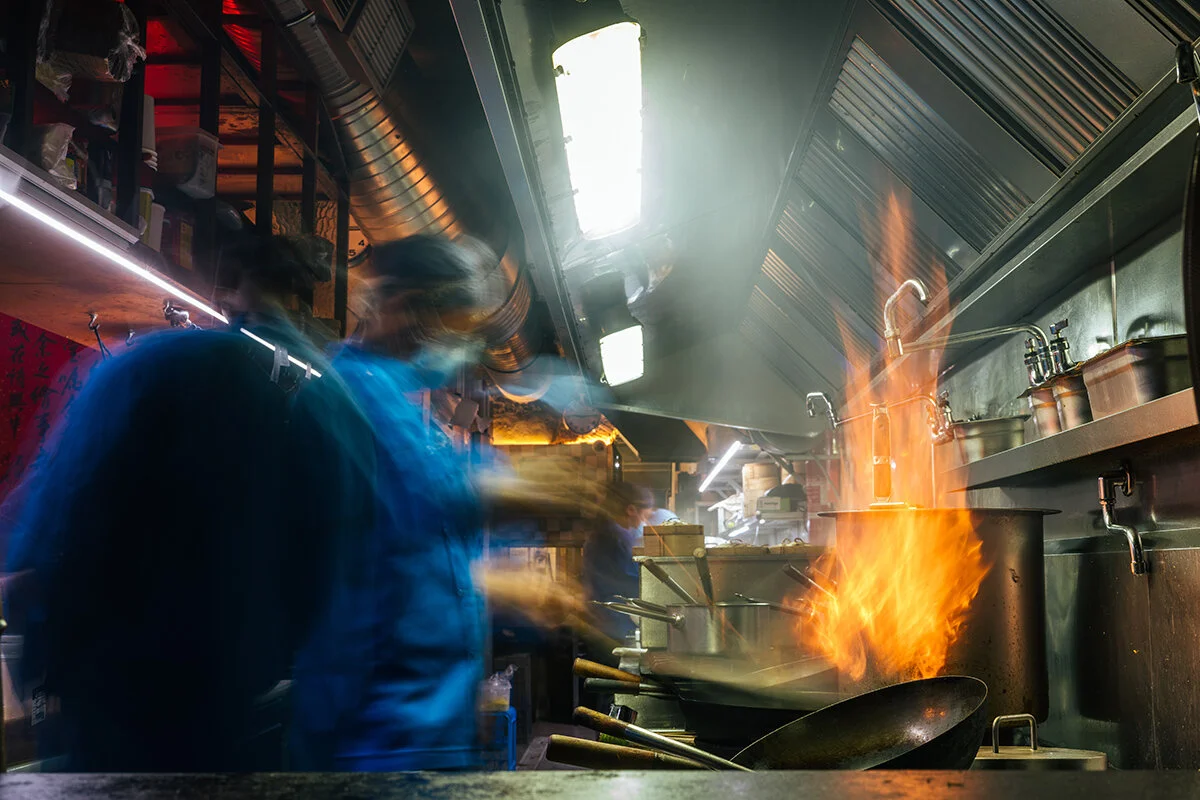Boa-Bao chefs cooking over flames in the open kitchen